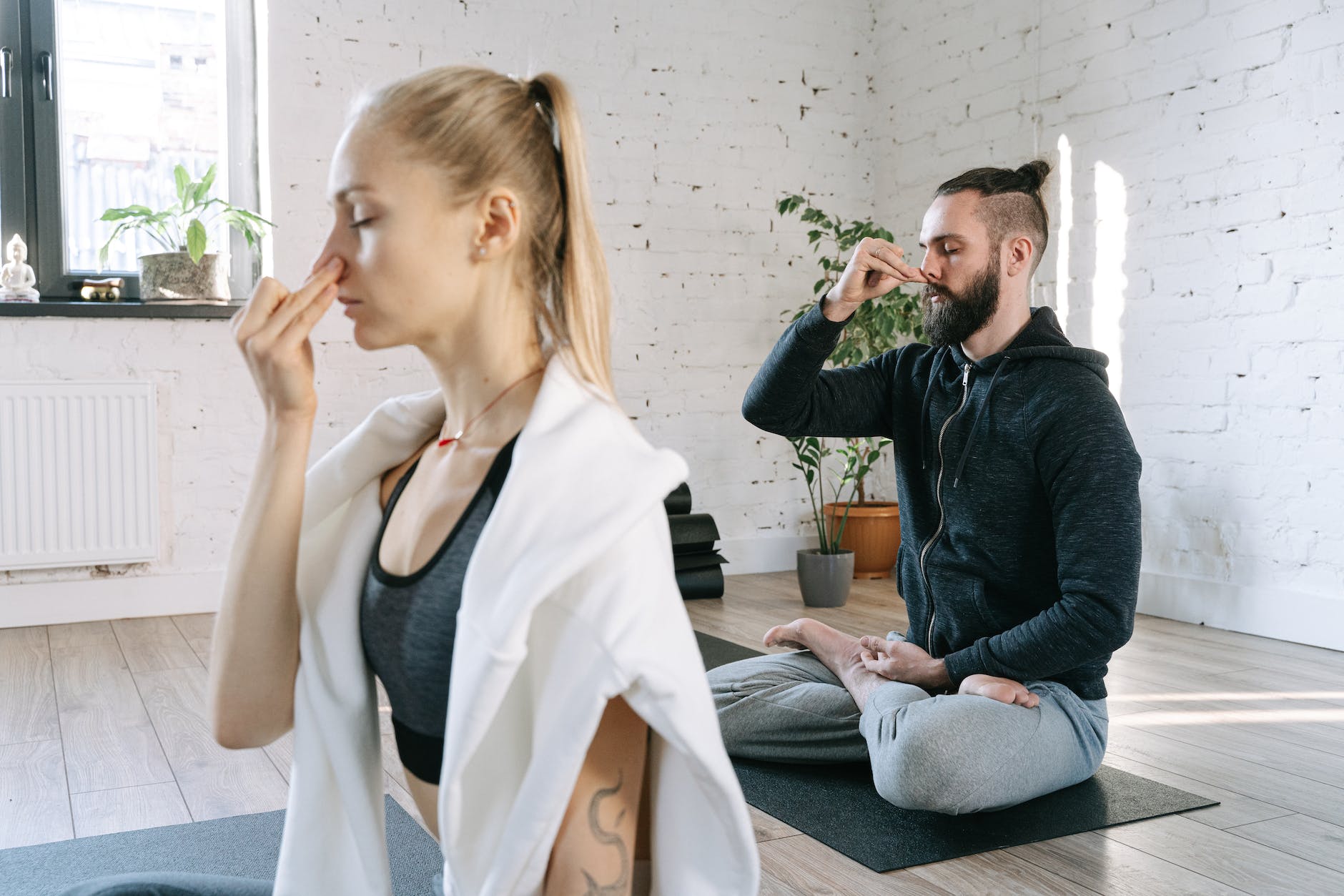 a man and a woman doing yoga