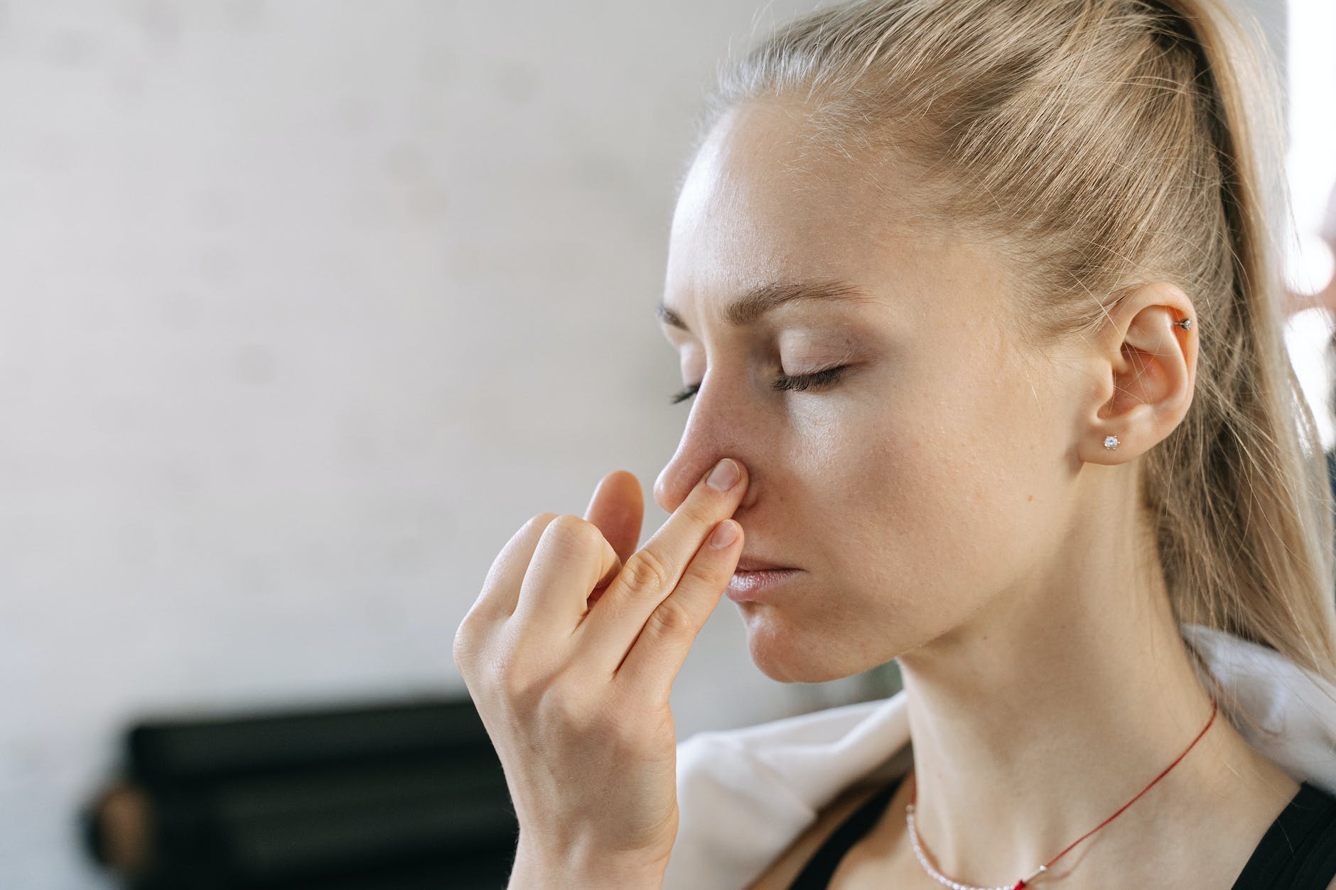 a woman doing nostril breathing